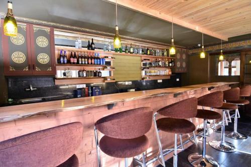 a bar with a row of bar stools at Hotel Valley Thimphu in Thimphu