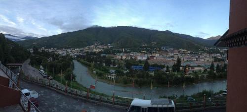 a view of a town with a river and a city at Hotel Valley Thimphu in Thimphu