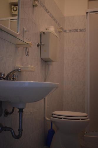 a bathroom with a sink and a toilet at Hotel Astoria in Pesaro