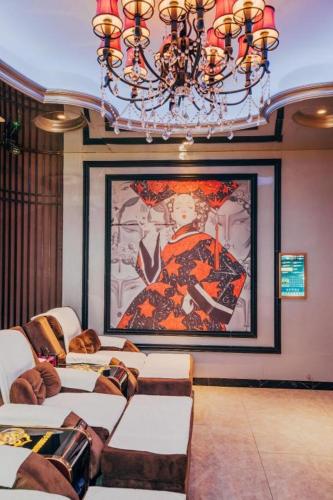 a living room with a large painting on the wall at Bati Holiday Hotel in Zhongshan