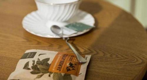 a table with a plate and a spoon and a napkin at James Joyce Coffetel Qufu Tourist Center Gulou Street Sankong Scenic Spot in Jining