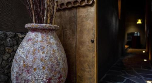 a large vase sitting next to a wall at Yufuin Luxury Villa -zakuro- in Yufuin
