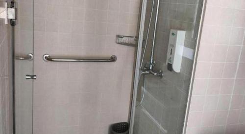 a shower with a glass door in a bathroom at Jinjiang Inn Style Shijiazhuang Zhongshan Xi Road Yuxi Park in Shijiazhuang