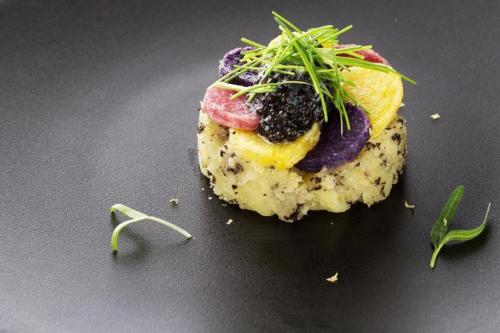 a piece of food with vegetables on top on a table at HOTEL FUTARI KOMOREBI in Atami