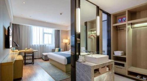 a hotel room with a bed and a bathroom with a sink at Echarm Hotel Nanning Chaoyang Square River View in Nanning