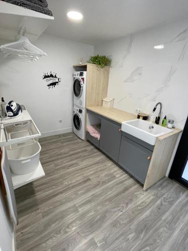 a kitchen with a sink and a washing machine at Heaven Ocin in Telde