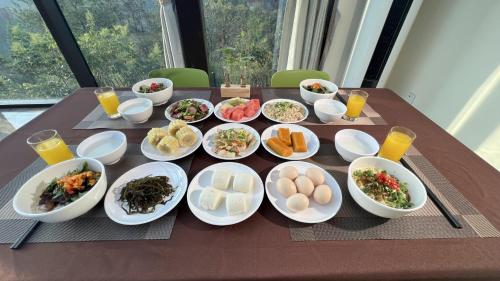 a table with plates of food and bowls of food at Avatar Valley Villas in Zhangjiajie