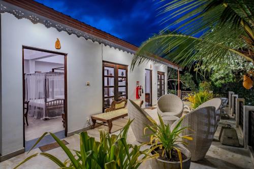 a patio with chairs and a table at Wasantha Garden Hotel Restaurant & Ayurvedic Treatment in Weligama
