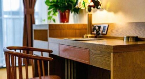 a kitchen with a counter with a sink and a chair at James Joyce Coffetel· Xianyang Renmin Road Central Square Store in Xianyang