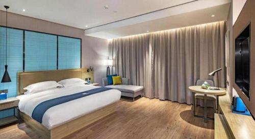 Ένα ή περισσότερα κρεβάτια σε δωμάτιο στο Echarm Hotel Guilin Railway Station the MixC