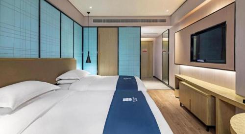 Ένα ή περισσότερα κρεβάτια σε δωμάτιο στο Echarm Hotel Guilin Railway Station the MixC