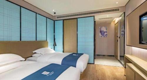 Ένα ή περισσότερα κρεβάτια σε δωμάτιο στο Echarm Hotel Guilin Railway Station the MixC