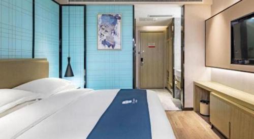 Ένα ή περισσότερα κρεβάτια σε δωμάτιο στο Echarm Hotel Guilin Railway Station the MixC