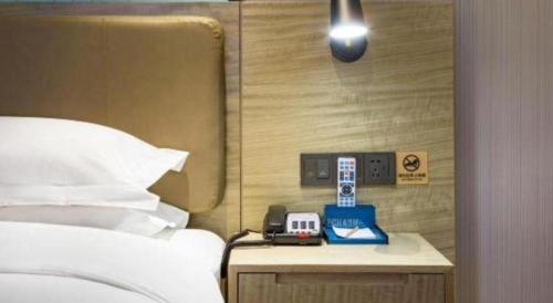Ένα ή περισσότερα κρεβάτια σε δωμάτιο στο Echarm Hotel Guilin Railway Station the MixC