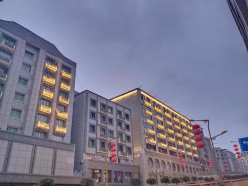 a large building with lights on in a city at PAI Hotel Nanchong Huaxi Normal University in Nanchong