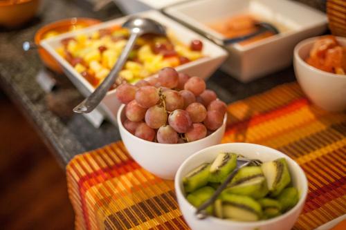 a buffet with bowls of fruit and other food at City Lodge Hotel Bryanston in Johannesburg