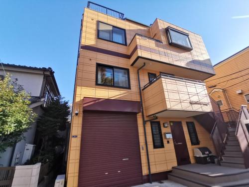 a house with a garage in front of it at Oasis Aoto in Tokyo