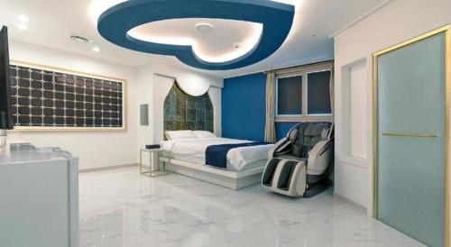 a bedroom with a bed and a blue wall at The Bay hotel & pool villa in Suncheon