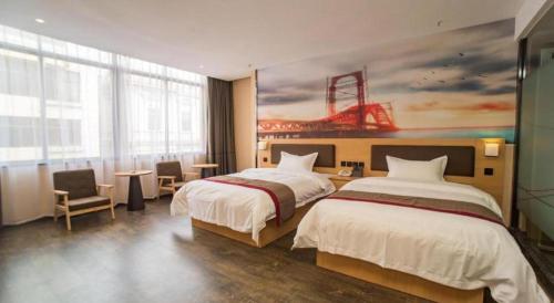 a hotel room with two beds and a painting on the wall at Thank Inn Plus Hotel Guangdong Yunfu Luoding City Municipal in Yunfu