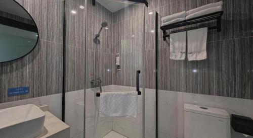 a bathroom with a shower and a toilet and a sink at Thank Inn Hotel Anqing Guangcai Big Market Passenger Center in Anqing