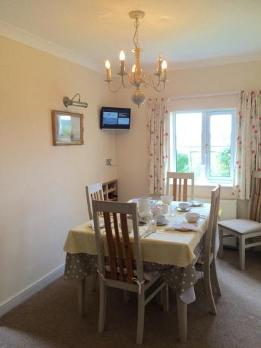a dining room with a table and chairs at Home from Home B&B in Hartland