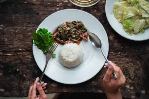 a table with a plate of food with rice at NernJamsai in Sop Poeng