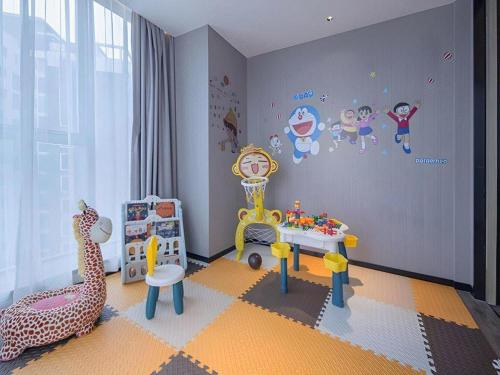 a childs play room with a giraffe and a table at Echarm Hotel Nanning the MixC Dongmeng Business District in Nanning
