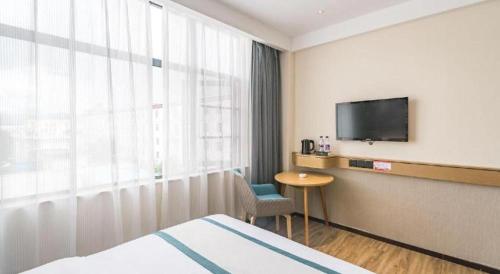 a hotel room with a bed and a television at City Comfort Inn Lhasa Potala Palace Scenic View in Lhasa