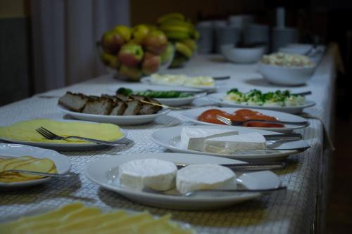 a long table with plates of food on it at Zajazd Saga in Gryfino