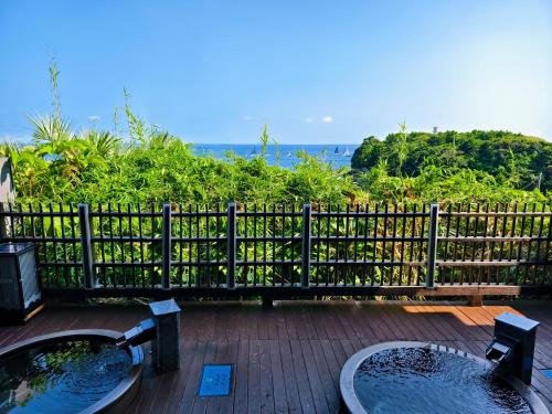 two sinks on a deck with a fence at NorthStar Sea Breeze Holiday Home in Shimoda