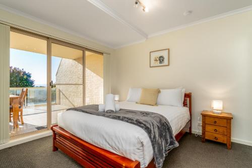a bedroom with a bed and a large window at Spacious 2BR APT Panoramic Views Central Location - Hosted by CanStay in Narrabundah