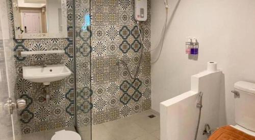 a bathroom with a shower and a sink at Thong Prachok Hotel in Sakon Nakhon