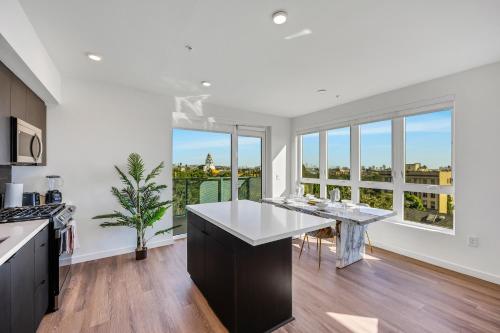 a kitchen with a table and a large window at One Lux Stay - Hollywood in Los Angeles