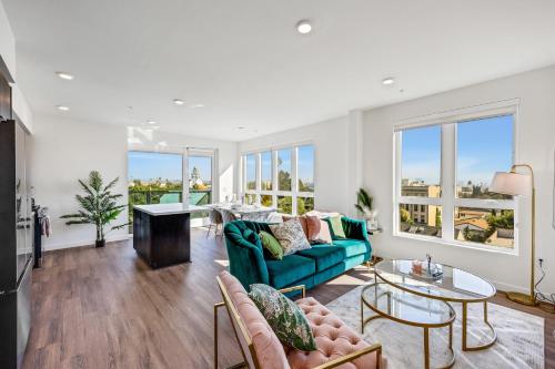 a living room with a couch and a table at One Lux Stay - Hollywood in Los Angeles