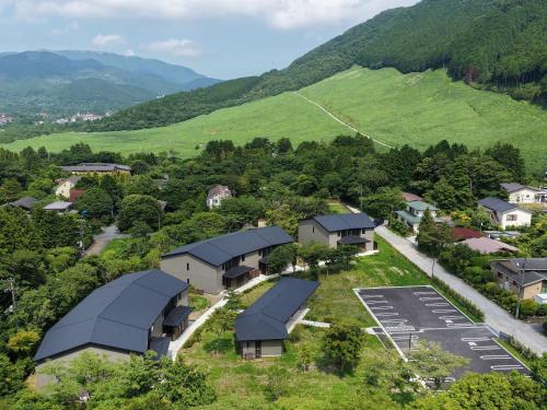 an aerial view of a village with houses and mountains at Rakuten STAY Hakone Susuki Grass Fields in Sengokuhara