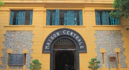 a yellow building with a sign that reads hotel center at Alice's home Times city in Hanoi