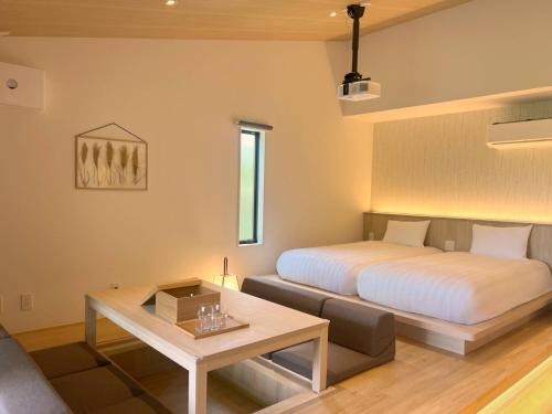 a bedroom with a bed and a couch and a table at Rakuten STAY Hakone Susuki Grass Fields in Sengokuhara