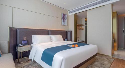 Ένα ή περισσότερα κρεβάτια σε δωμάτιο στο Echarm Hotel Zhuzhou Liling