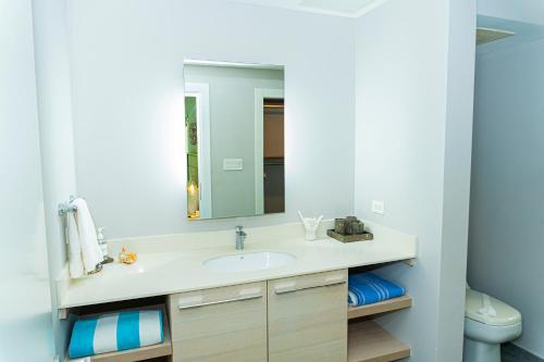 a bathroom with a sink and a mirror at Elan at Ballena Beach in Uvita