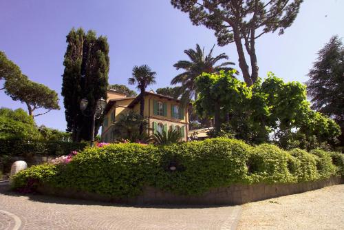 a house with trees and bushes in front of it at Residence Verdeborgo in Grottaferrata