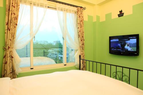 Ένα ή περισσότερα κρεβάτια σε δωμάτιο στο 花蓮狗go快樂寵物民宿