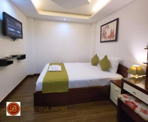 a hotel room with a bed and a tv at Beautiful Hotel Bui vien in Ho Chi Minh City