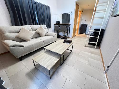 a living room with a couch and a coffee table at VESSEL Inn in Fukuoka