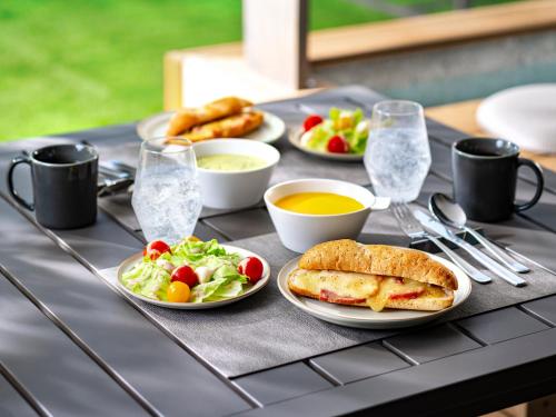 a table with plates of food on a table at Rakuten STAY Hakone Susuki Grass Fields in Sengokuhara