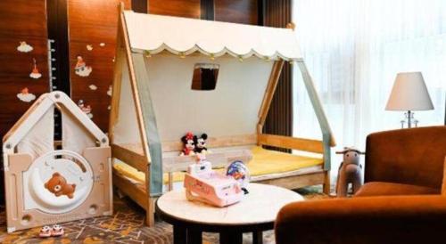 a childs bedroom with a bed with a toy house at Royal Tulip Hotel Zhujiajiao Shanghai in Shanghai