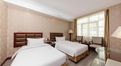 Katil atau katil-katil dalam bilik di Zhenxing Hotel