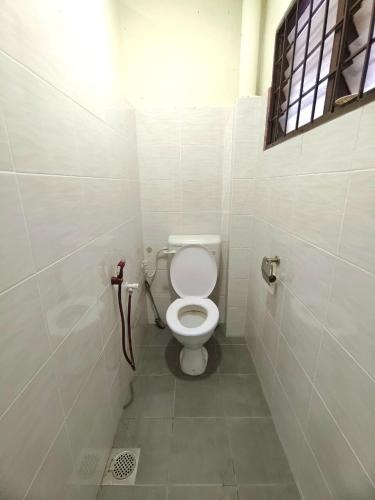 a bathroom with a toilet in a stall at Lighthouse Tmn Intan 6pax Water Dispenser Neflix Target in Kluang