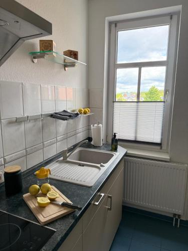 a kitchen counter with a sink and a window at Ferienwohnung Stein-16 zum Prinzenweg in Oberhof