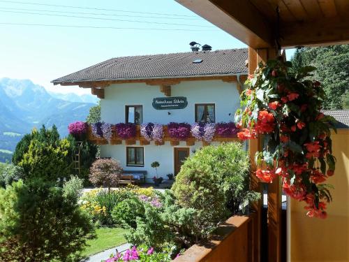 a house with flowers in front of it at Haus Silvia in Werfenweng