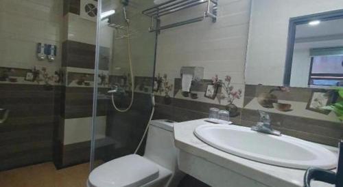 a bathroom with a sink and a toilet and a shower at Ha Noi Vang Hotel Hoang Ngan in Hanoi